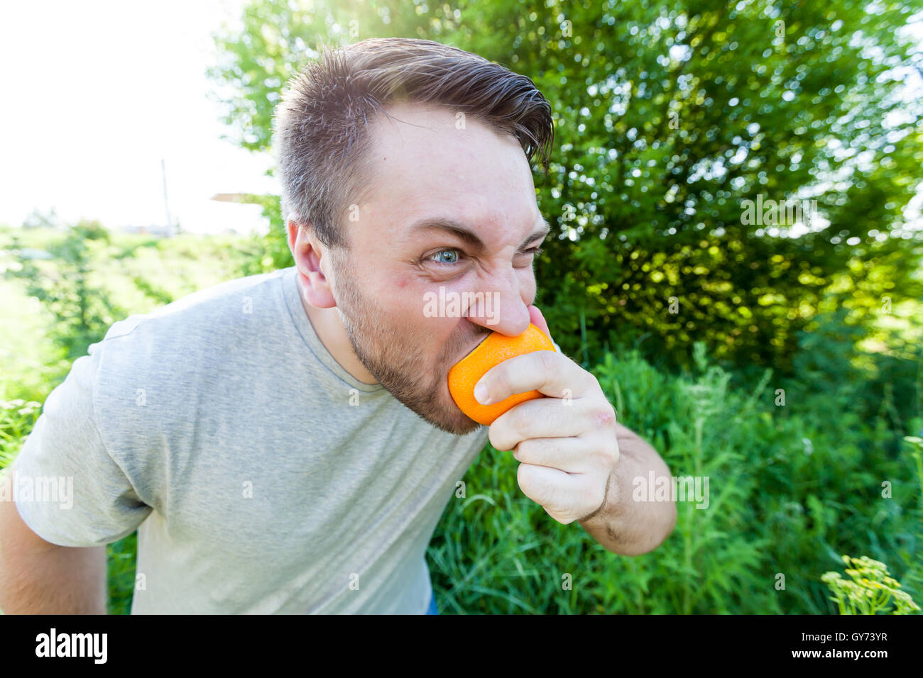 Man eating oranger Stock Photo