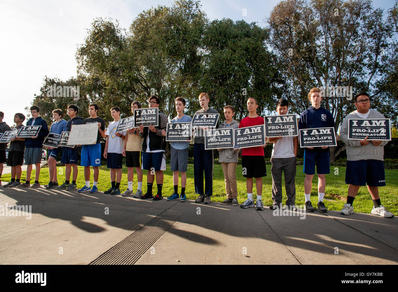An all-male group of Catholic teen and boy protesters holds an anti abortion demonstration outside a branch of Planned Parenthood in Mission Viejo, CA. Stock Photo
