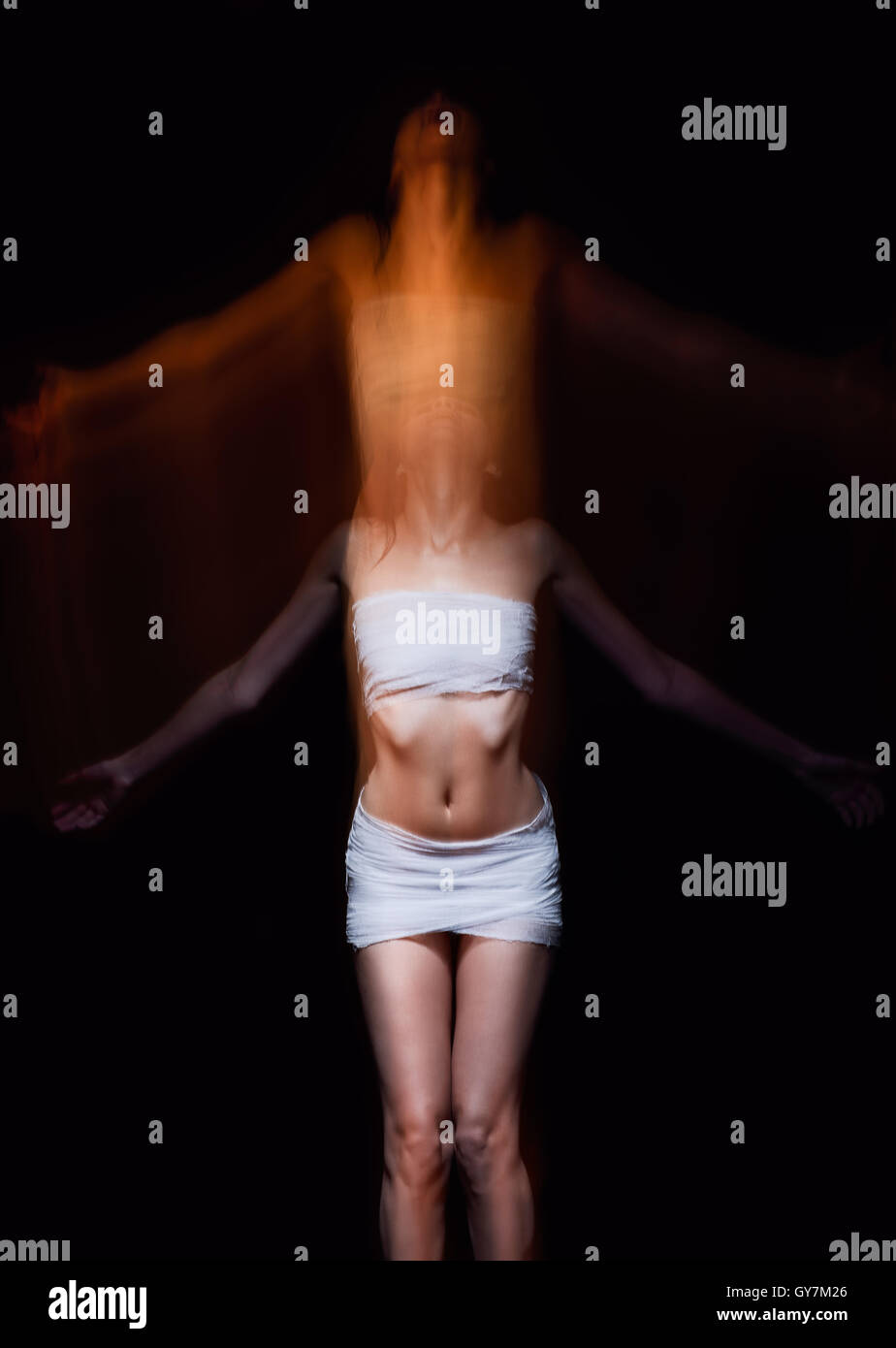 Horror shot: soul is leaving body of a woman. Blurry effect Stock Photo
