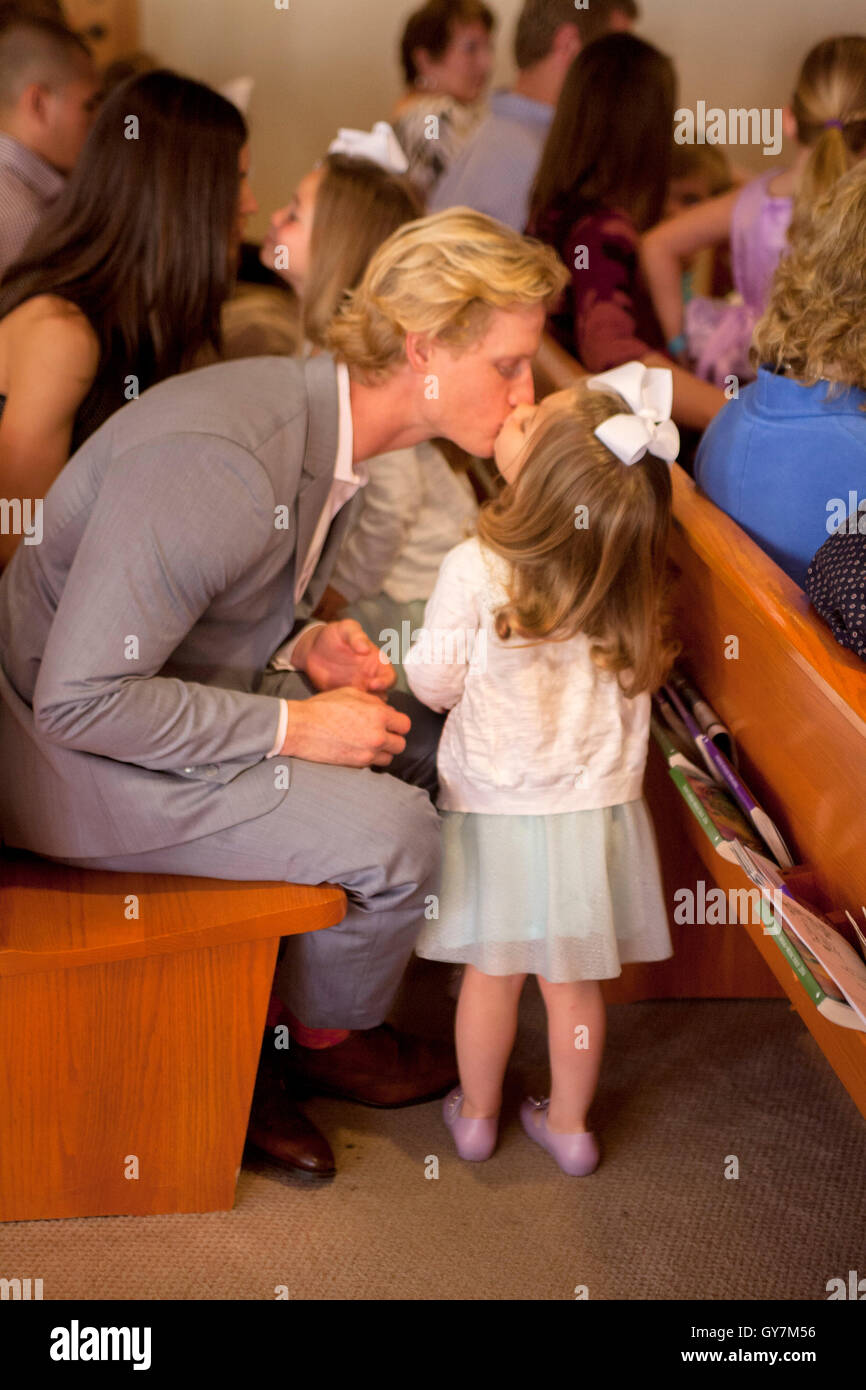 A little girl kisses her father affectionately in a pew during services at a Laguna Niguel, CA, church. Stock Photo