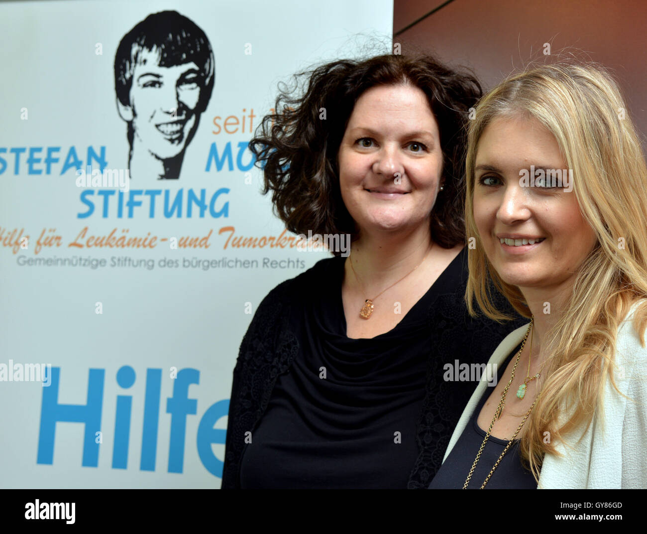 Birkenfeld, Germany. 17th Sep, 2016. Former model Felicity Gain (R) from London and Siobhan Kirsten Mansfield pose in front of a poster from the Stefan Morsch Foundation in Birkenfeld, Germany, 17 September 2016. In 2002, 44-year-old Mansfield from Trassem, Germany donated bone marrow for Felicity Gain, now 38, which saved her life. Phoot: HARALD TITTEL/dpa/Alamy Live News Stock Photo