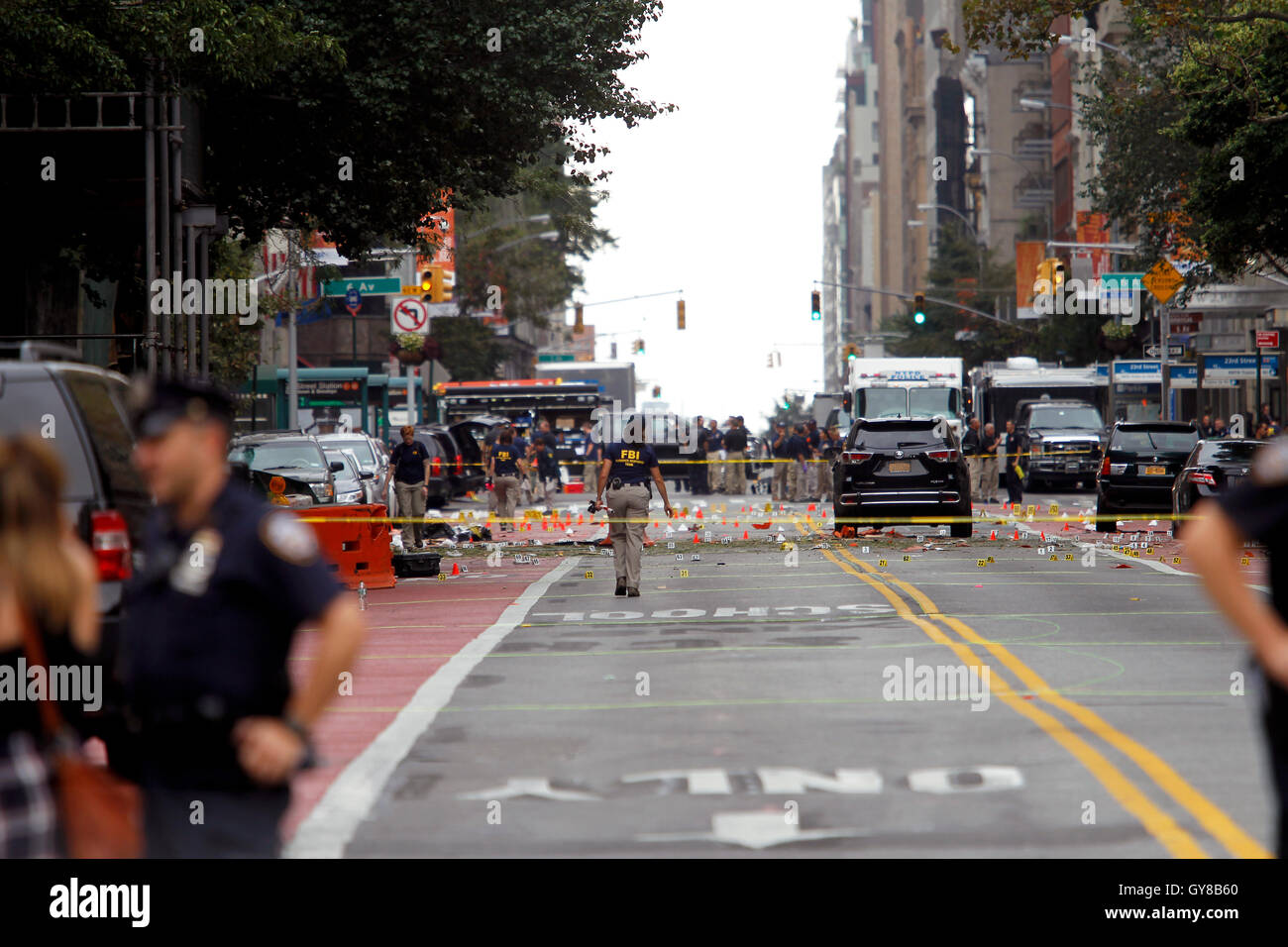 New York, USA. 18th Sep, 2016. Police, and law enforcement personnel from various agencies examine the area for clues after last night's explosion on New York's West 23rd Street between 6th and 7th Avenues in the Chelsea section of Manhattan. the view is looking east on 23rd street from 7th Avenue towards 6th Avenue. The area is marked for clues amidst the debris. 29 people were injured in the blast which has been described by officials as intentional. Credit:  Adam Stoltman/Alamy Live News Stock Photo