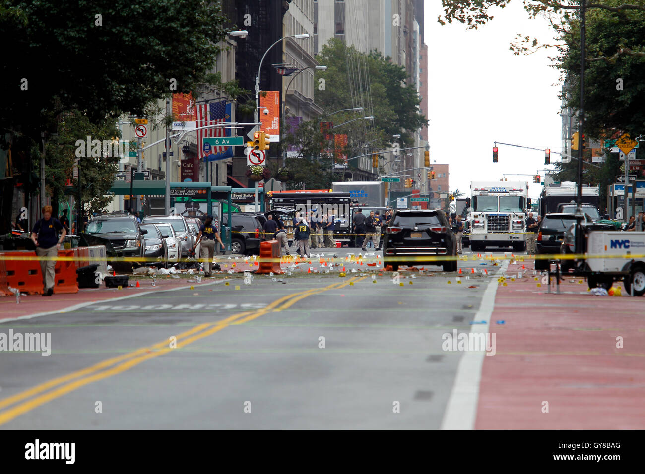 New York, USA. 18th Sep, 2016. Police, and law enforcement personnel from various agencies examine the area the morning after last night's explosion on New York's West 23rd Street between 6th and 7th Avenues in the Chelsea section of Manhattan.  the view is looking east on 23rd street from 7th Avenue towards 6th Avenue.  The area is marked for clues amidst the debris.  29 people were injured in the blast which has been described by officials as intentional. Credit:  Adam Stoltman/Alamy Live News Stock Photo