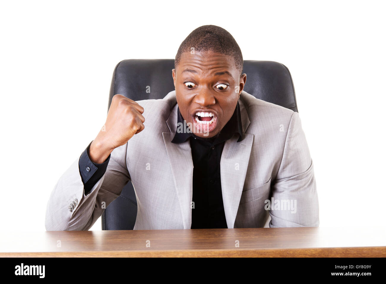 Male businessman sitting in a chair, angry Stock Photo Alamy