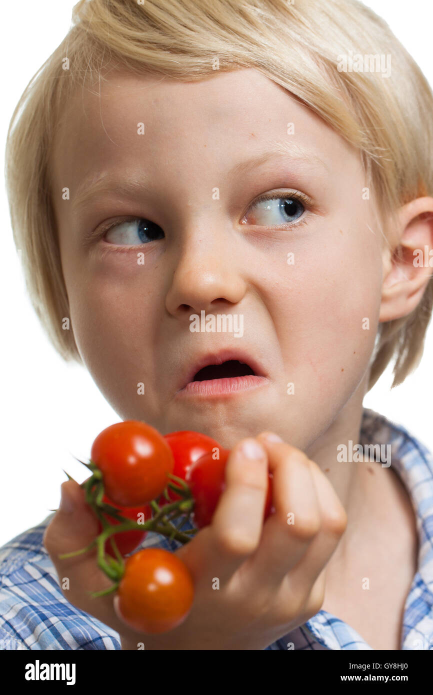 Funny boy holding bunch of tomatoes Stock Photo - Alamy