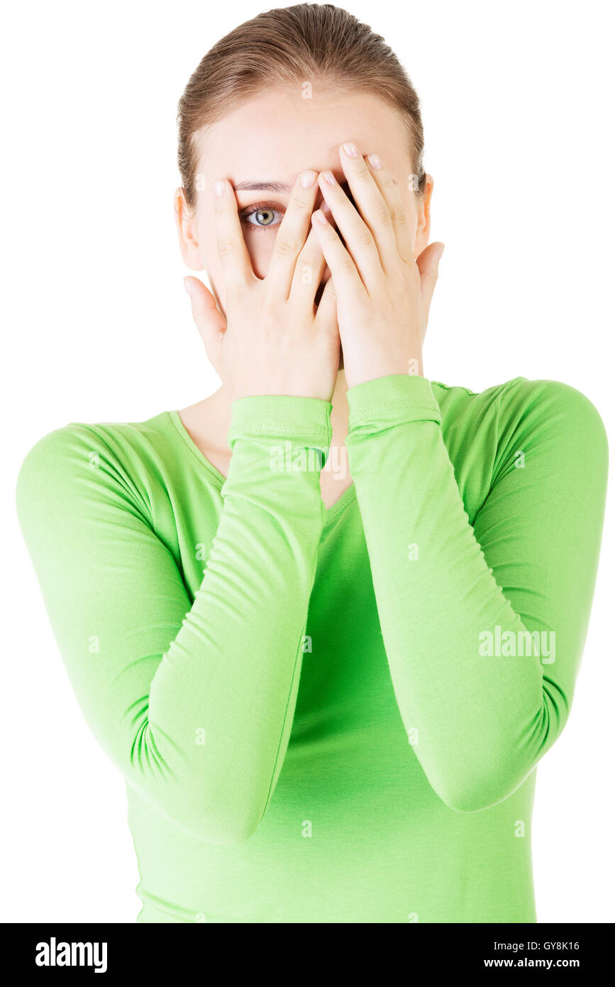 Attractive woman covering her face with both hands Stock Photo - Alamy