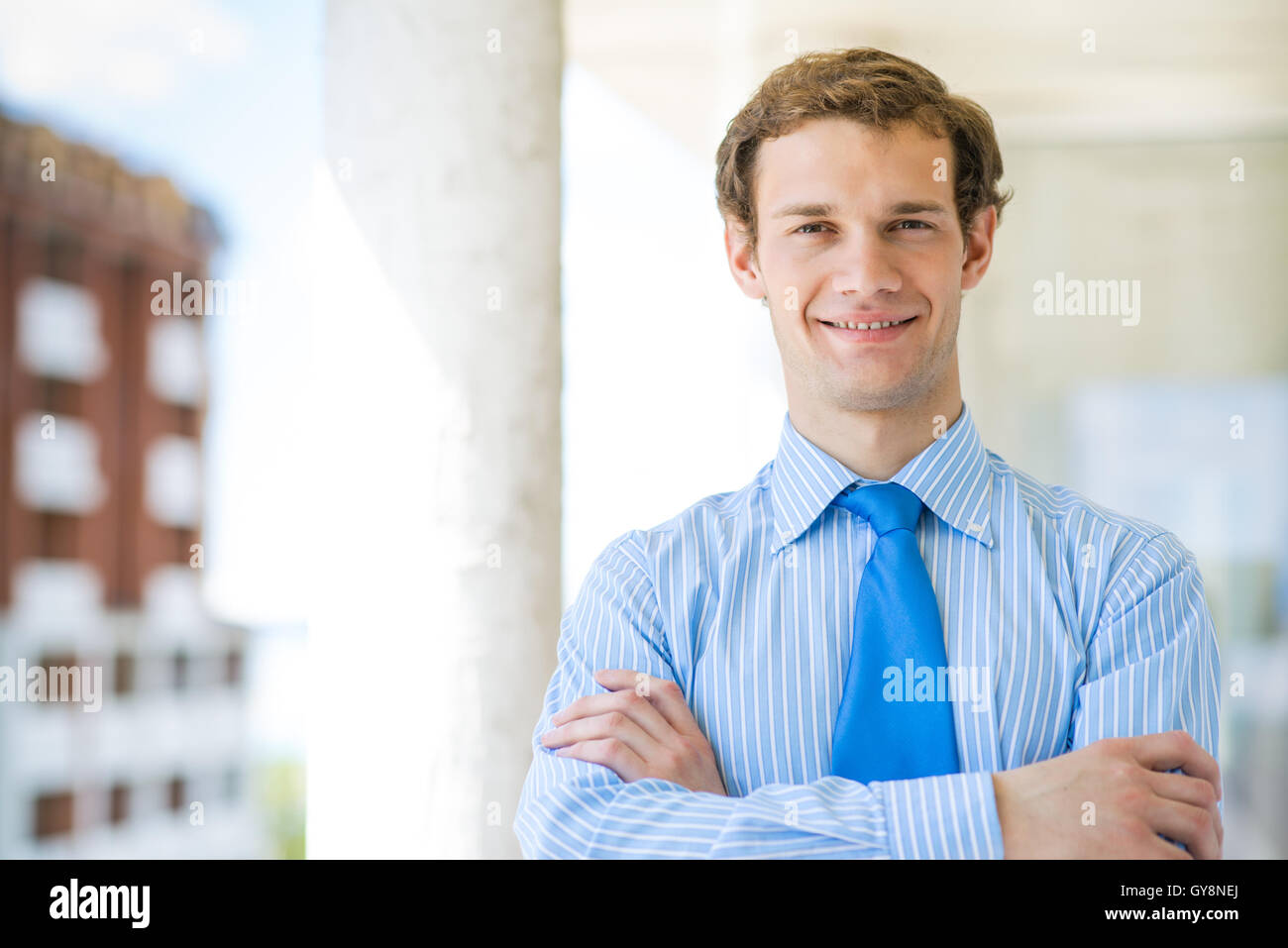 successful young businessman smiling Stock Photo - Alamy