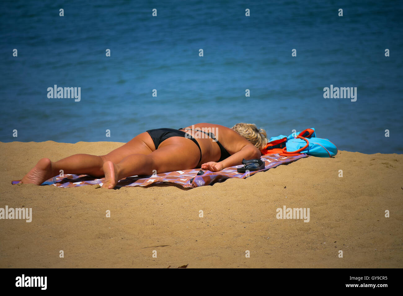 Tourist sun bathing in Tobago Stock Photo