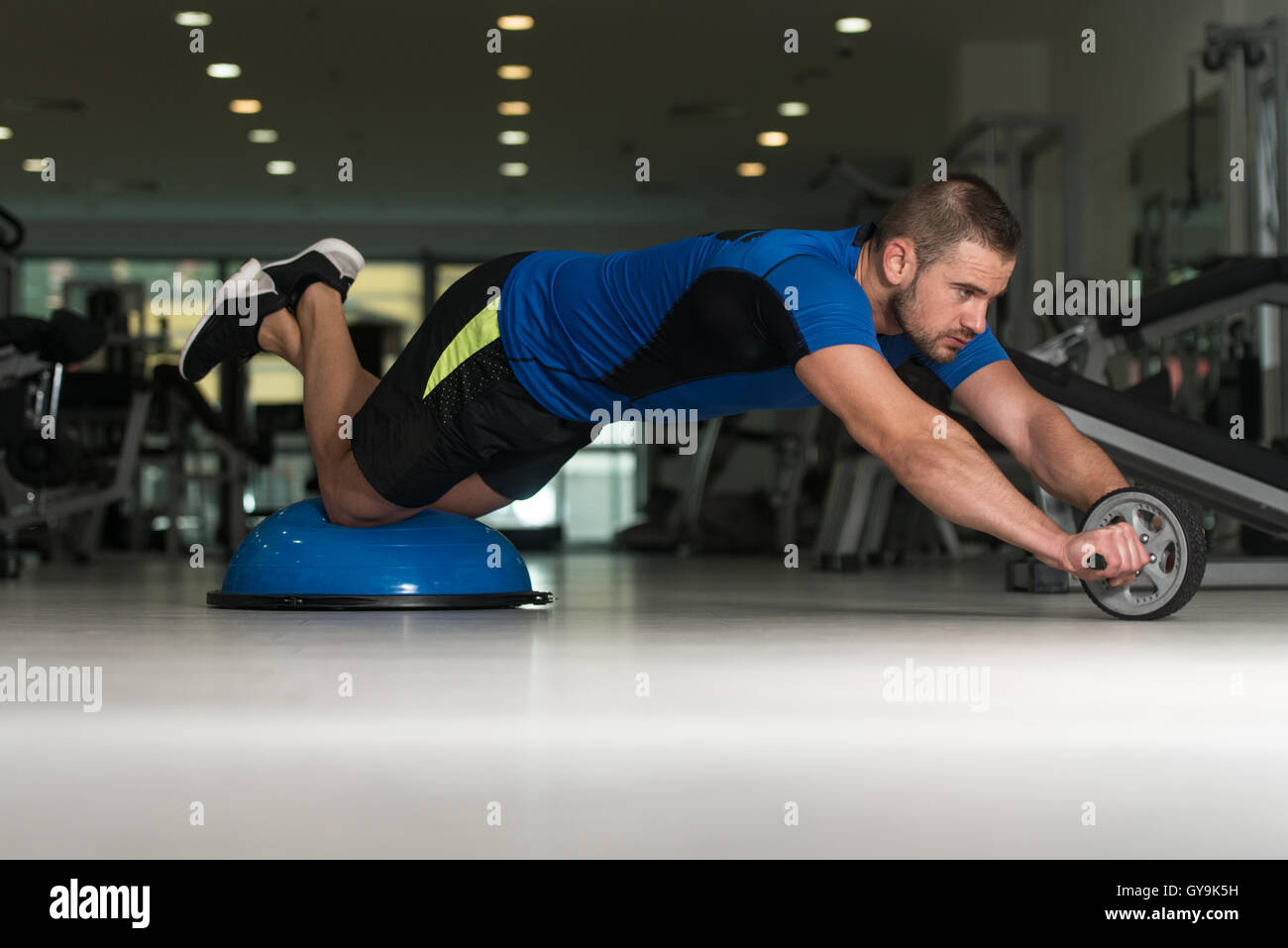 Personal Trainer Doing A Exercise For Abs With Bosu Balance Ball As