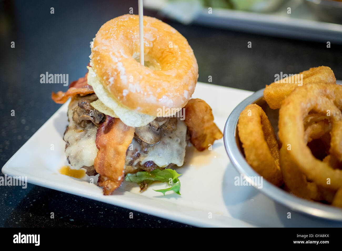A bacon donut burger (Luther Burger) from Soda Jerks restaurant in Edmonton, Alberta, Canada. Stock Photo