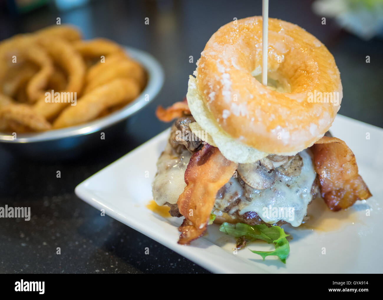 A bacon donut burger (Luther Burger) from Soda Jerks restaurant in Edmonton, Alberta, Canada. Stock Photo