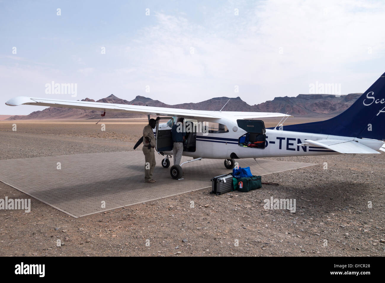 Passengers luggage being loaded into light aircraft flying between Swakopmund and Sossusvlei, Namibia Stock Photo