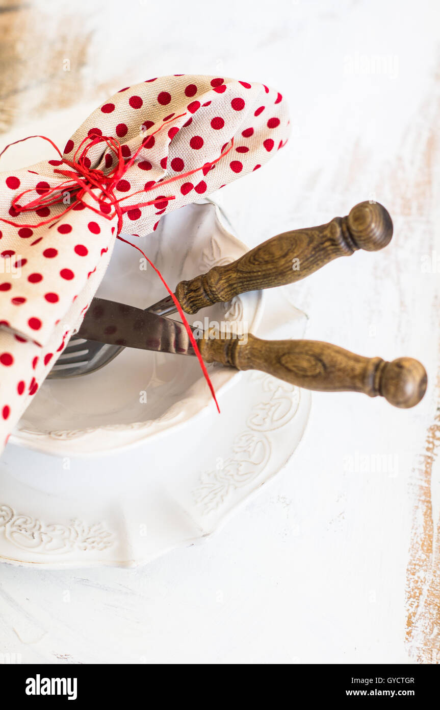 Table setting with vintage plate and silverware on rustic style napkin ...