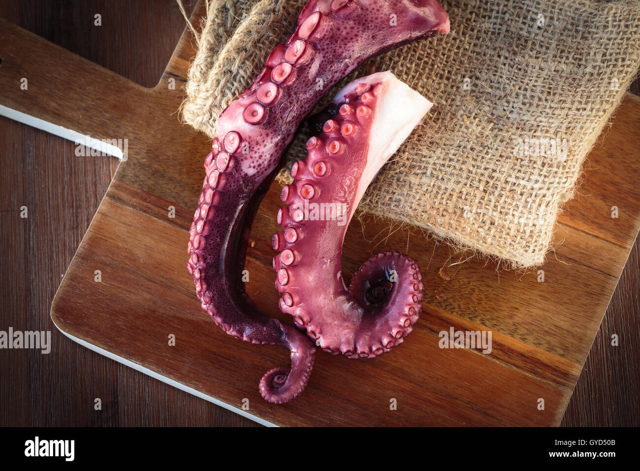 Delicious cooked octopus tentacles on a chopping board Stock Photo - Alamy