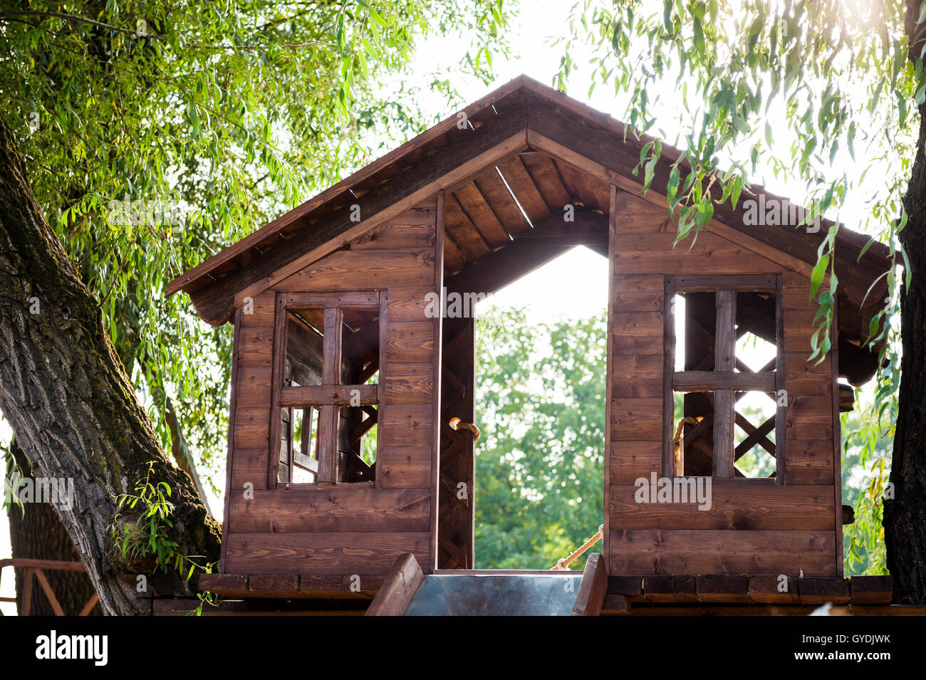 tree house with a slide on the playground at daytime Stock Photo