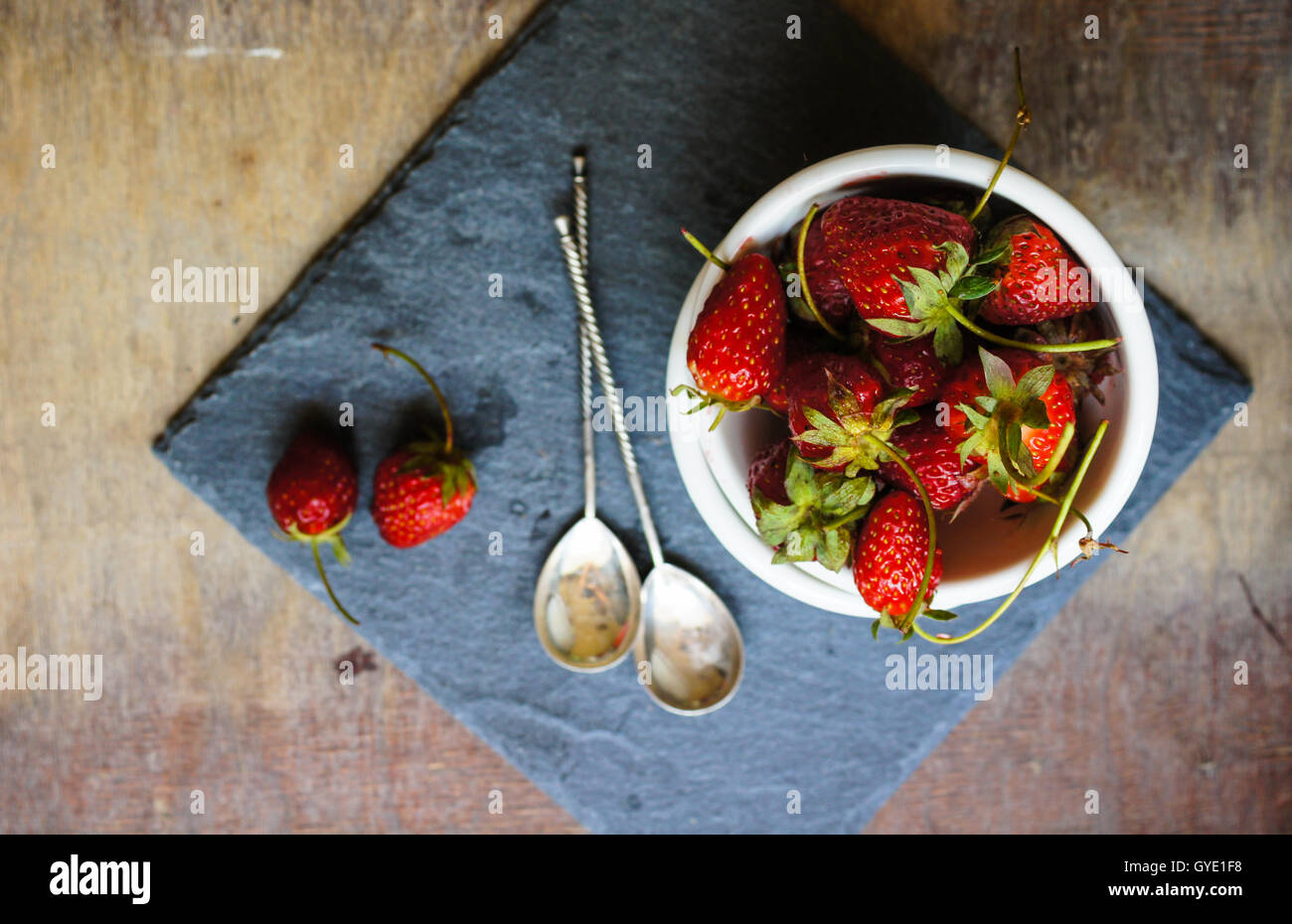 Fresh strawberries on the old wooden background Stock Photo - Alamy