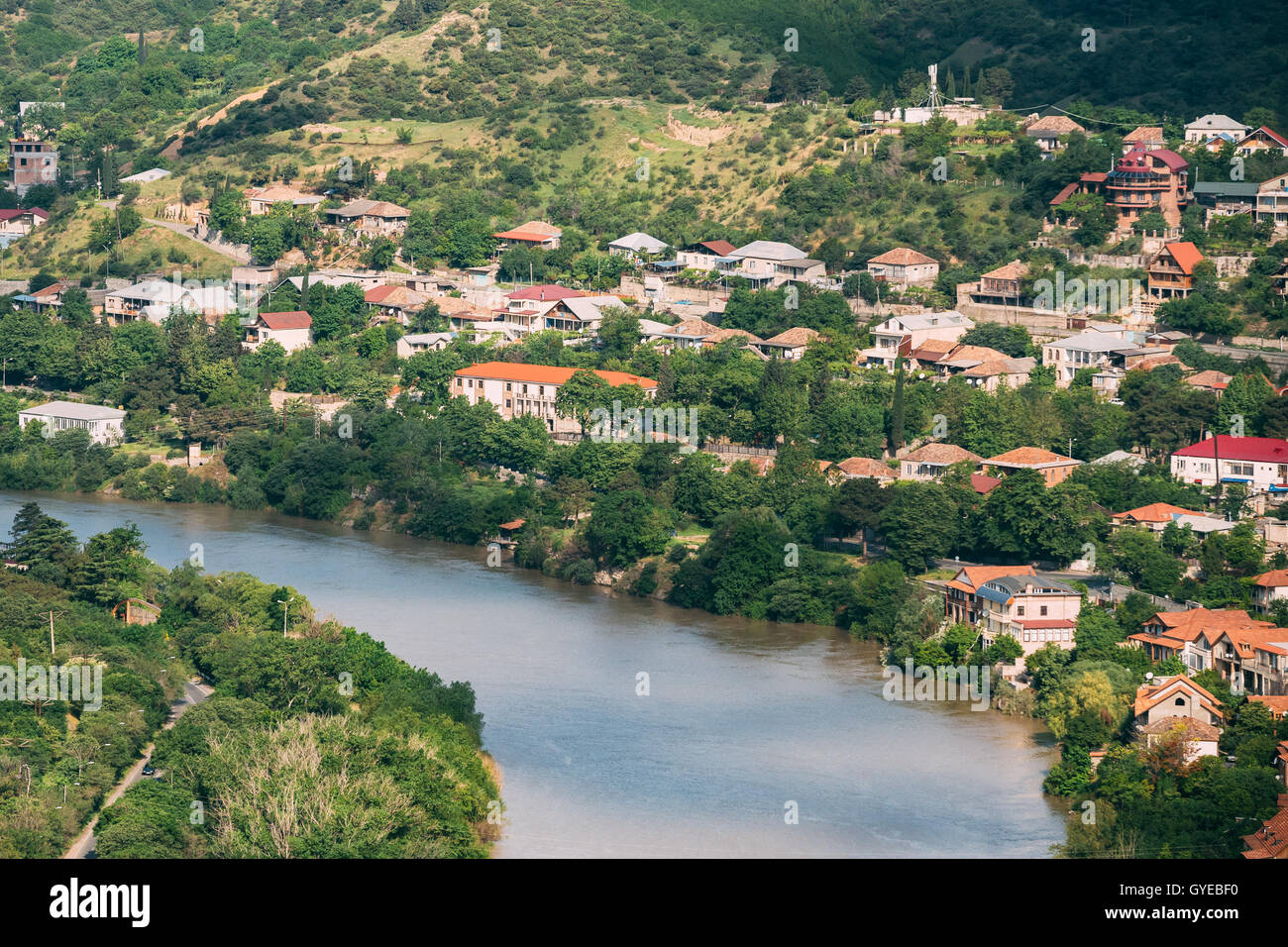 The Scenic Top View Of Mtskheta, Georgia. The Residential Area Along Bank Of The Aragvi River In Summer Sunny Day. Stock Photo