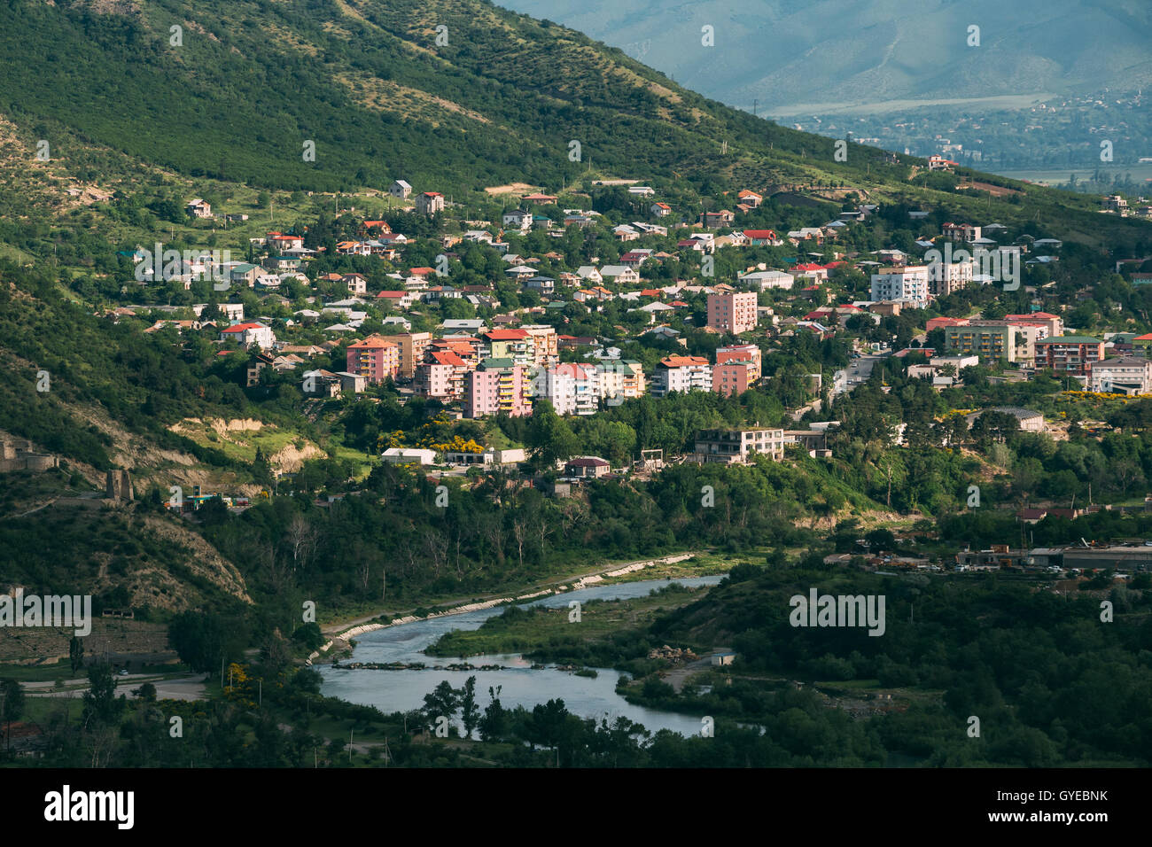 The Scenic View Of Mtskheta, Georgia. Uptown, The Residential Area On Green Hillside By The Mountain River In Summer Sunny Day. Stock Photo