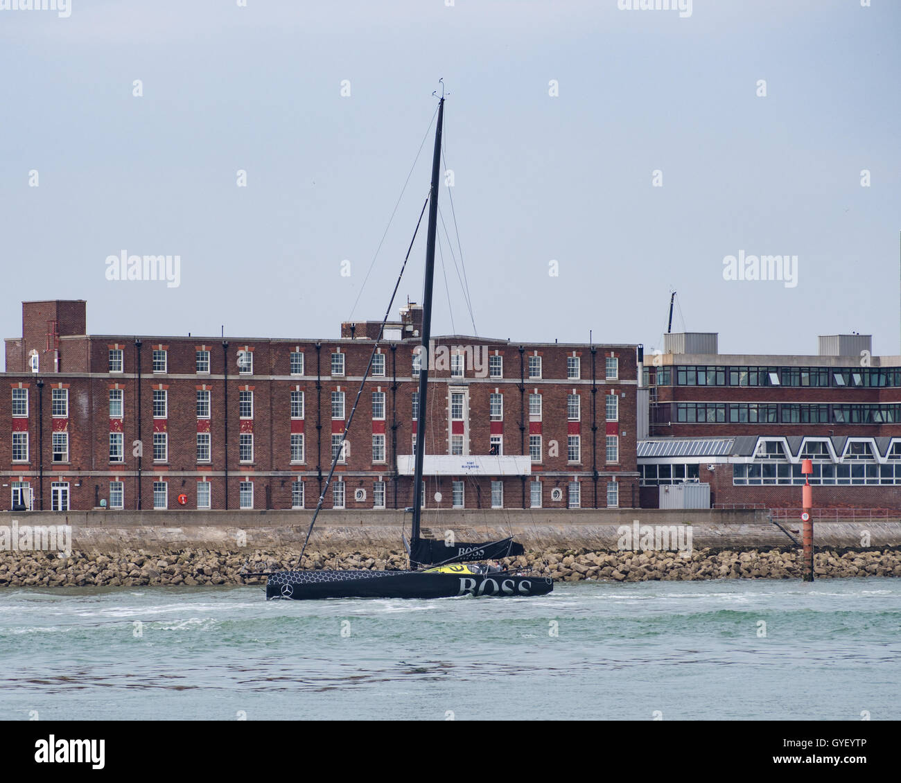 Alex Thomson racing IMOCA 60 racing yacht leaving Portsmouth Harbour, England Stock Photo