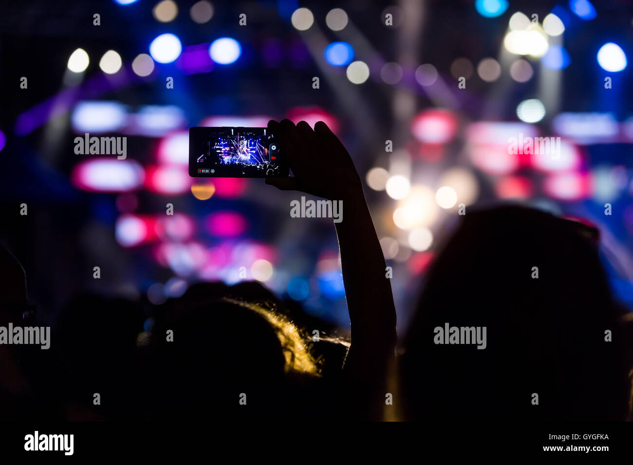 Hand with a smartphone records live music festival, Taking photo of concert stage, live concert, music festival, happy youth, lu Stock Photo