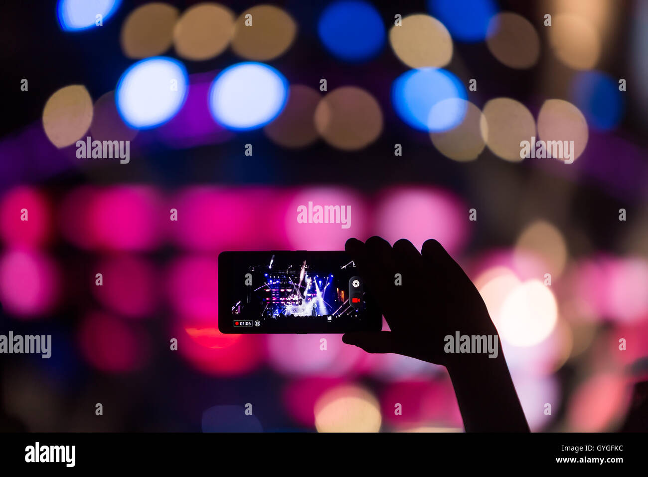 Hand with a smartphone records live music festival, Taking photo of concert stage, live concert, music festival, happy youth, lu Stock Photo