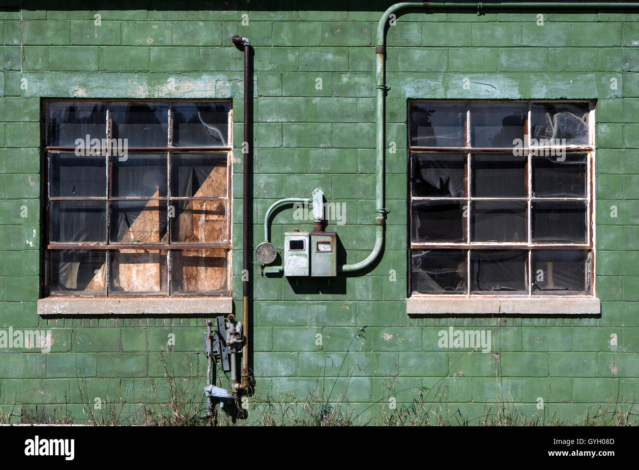 Old gas and electric pipework on a derelict building Stock Photo