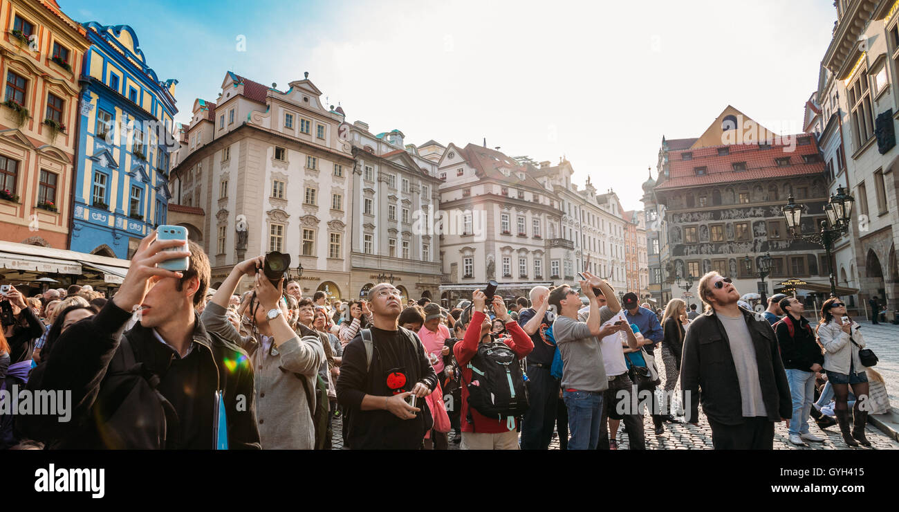 Prague, Czech Republic - October 13, 2014: Group of tourists taking photo of town hall with astronomical clock - Orloj Stock Photo