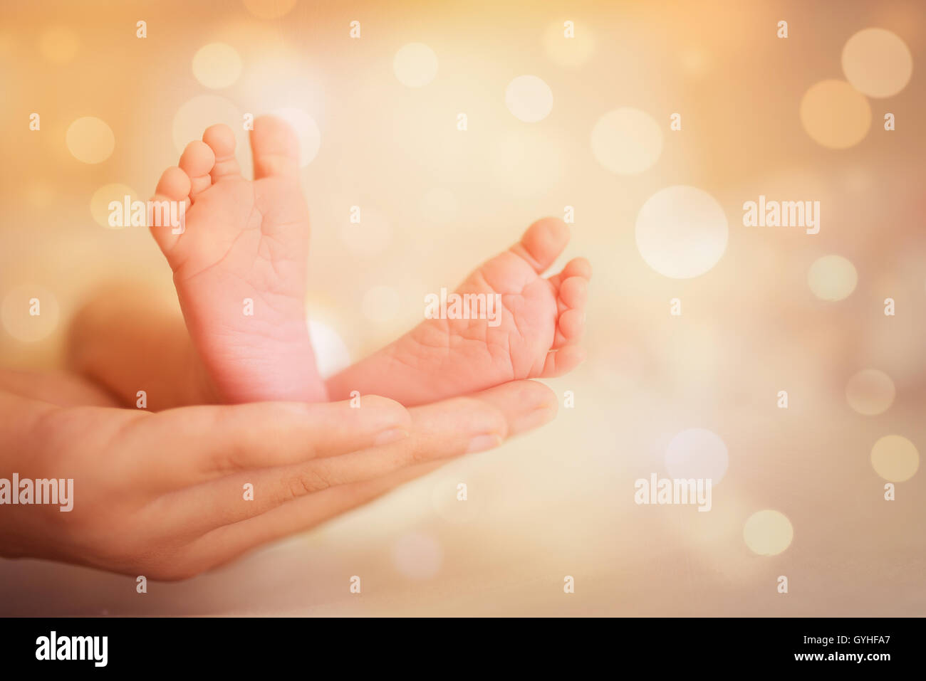 mother hold feets of newborn baby Stock Photo