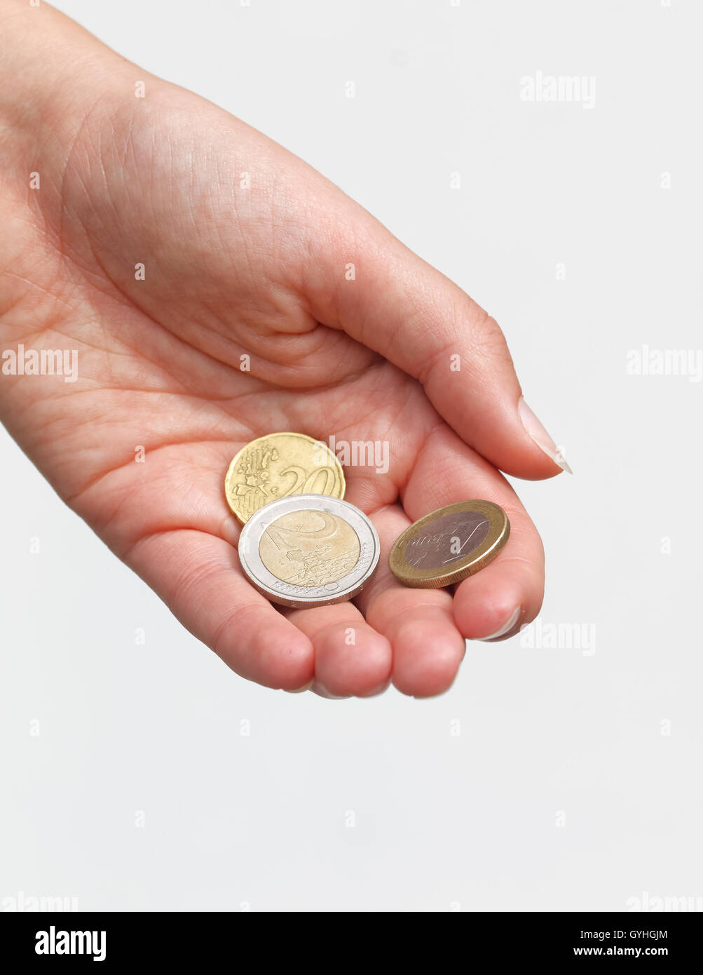 Paying - Hand giving some Euro coins Stock Photo