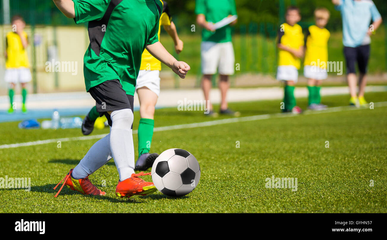 Training and football match between youth soccer teams. Young boys