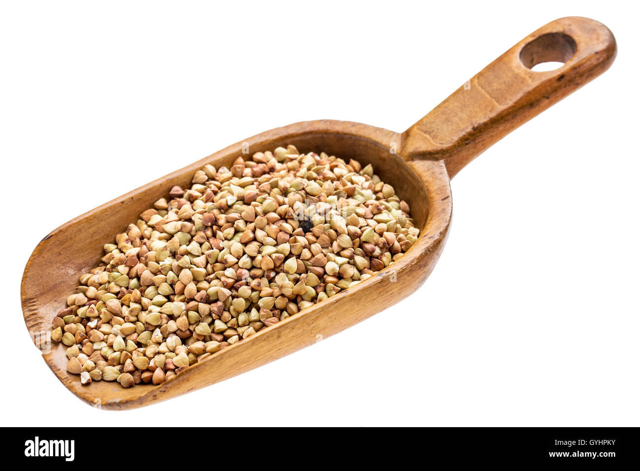 gluten free buckwheat grain on a rustic wooden scoop isolated on white