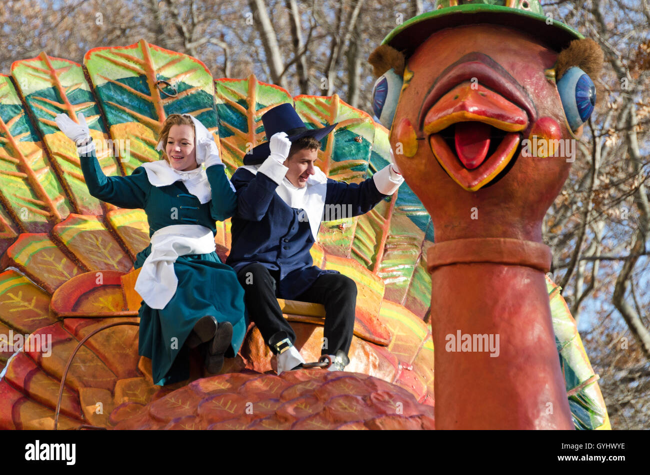 A Pilgrim couple waves from the Tom Turkey float in the Macy's Thanksgiving Day Parade, New York City. Stock Photo