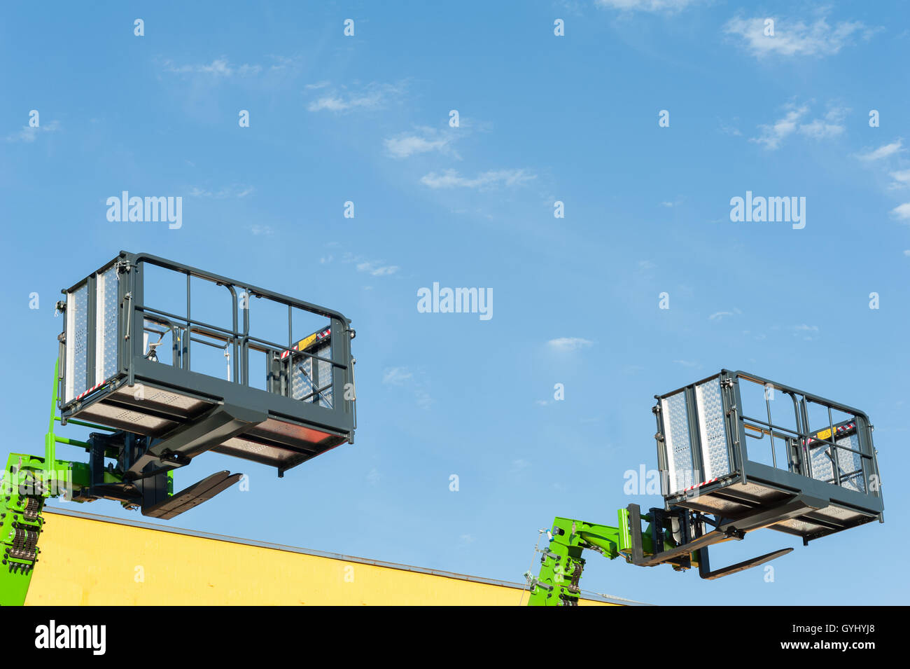 Forklift telescopic boom with buckets and aerial working platform. Stock Photo