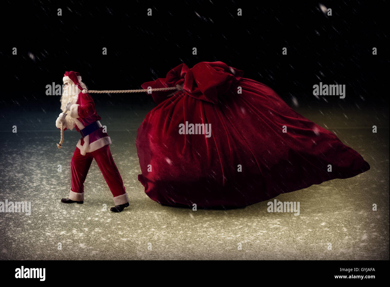 Santa Claus pulls a huge bag of gifts Stock Photo - Alamy