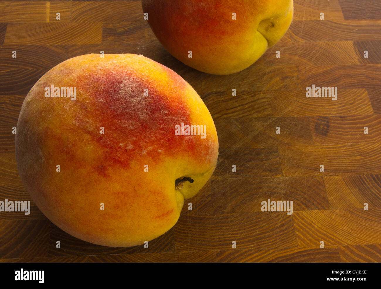 big ripe peaches on a wooden background Stock Photo - Alamy