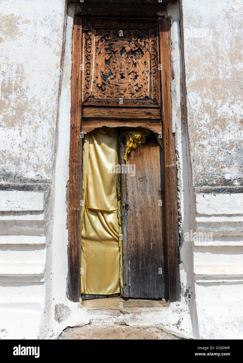 Old broken door to the ancient church of the Thai temple .(Public area not required Property Release) Stock Photo
