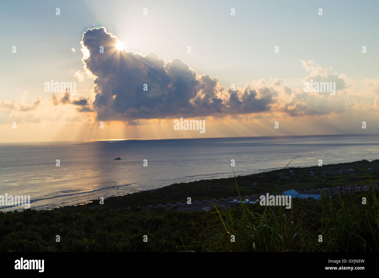 Sun going down behind dramatic clouds Stock Photo Alamy