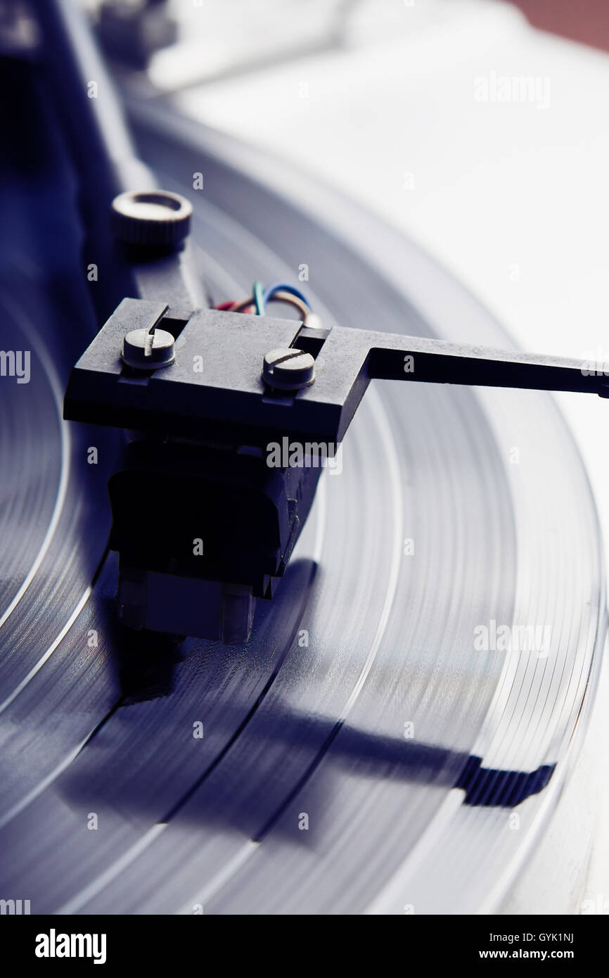 Turntable player with musical vinyl record. Useful for DJ, nightclub and retro theme. Stock Photo