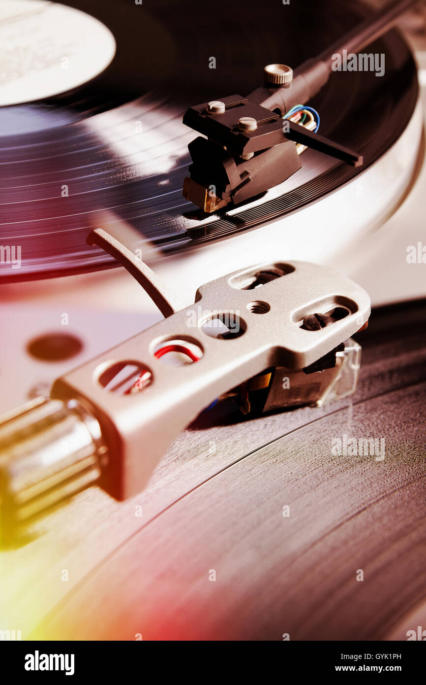 Turntable player with musical vinyl record. Useful for DJ, nightclub and retro theme. Light leak hipster film effect Stock Photo