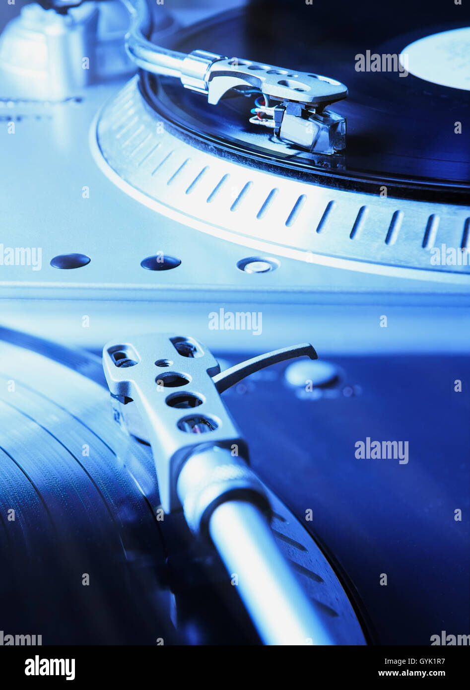 Turntable player with musical vinyl record. Useful for DJ, nightclub and retro theme. Saturated blue color Stock Photo