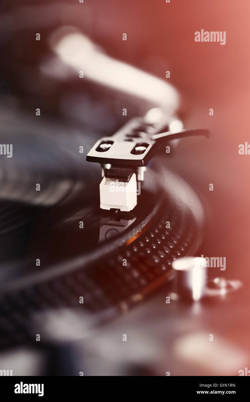 Turntable vinyl record player, analog sound technology for DJ playing analog and digital music. Close up, macro of equipment for professional studio, concert, event. Stock Photo