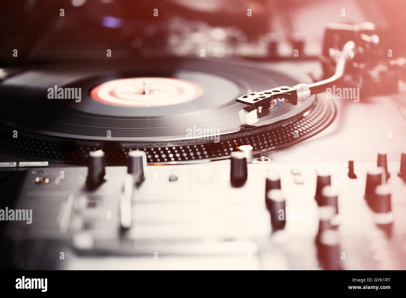 Turntable vinyl record player, analog sound technology for DJ playing analog and digital music. Close up, macro of equipment for professional studio, concert, event. Stock Photo