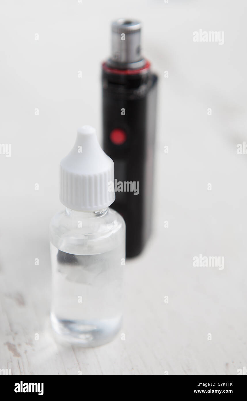 Plastic container with e-juice or e-liquid for e-cig.Fill your vaping device with this tasty filling.Refill liquid with propylen glicol and glycerin base.Place text on transparent bottle. Stock Photo