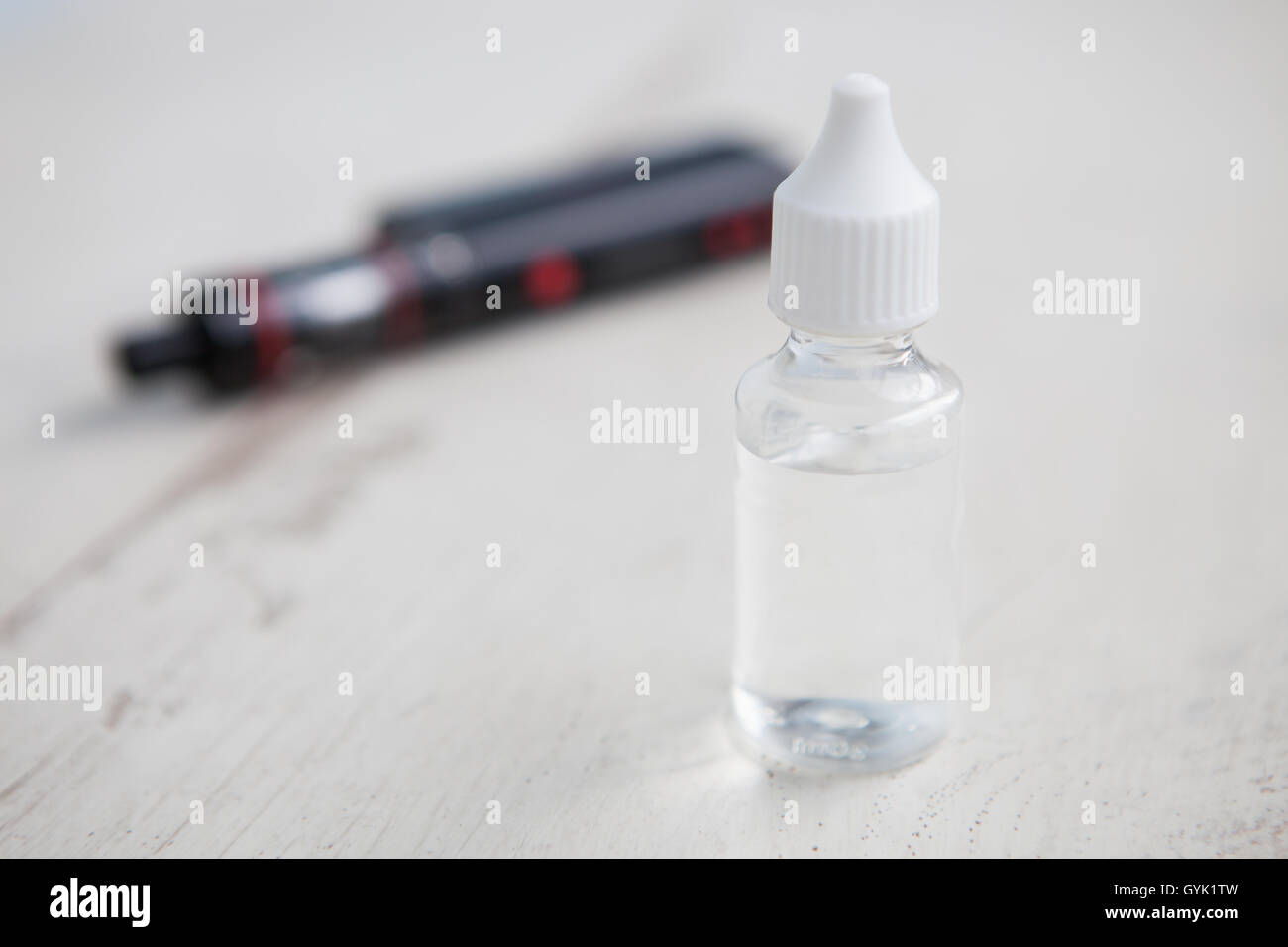 Popular vaping e-liquid filling with tasty fruit or pastry flavour. Vaporizer and refilling e-juice. Refill liquid tobacco with propylen glicol and glycerin base.Place text on transparent bottle. Stock Photo