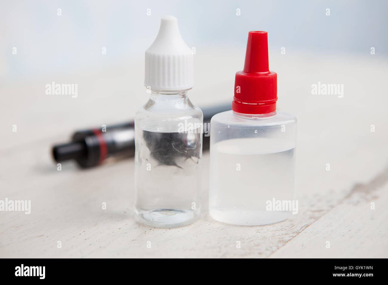 E-juice or e-liquid for vaping device vaporizer.Smoke safely.Refill liquid tobacco with propylen glicol and glycerin base. Place text on transparent bottle. Stock Photo