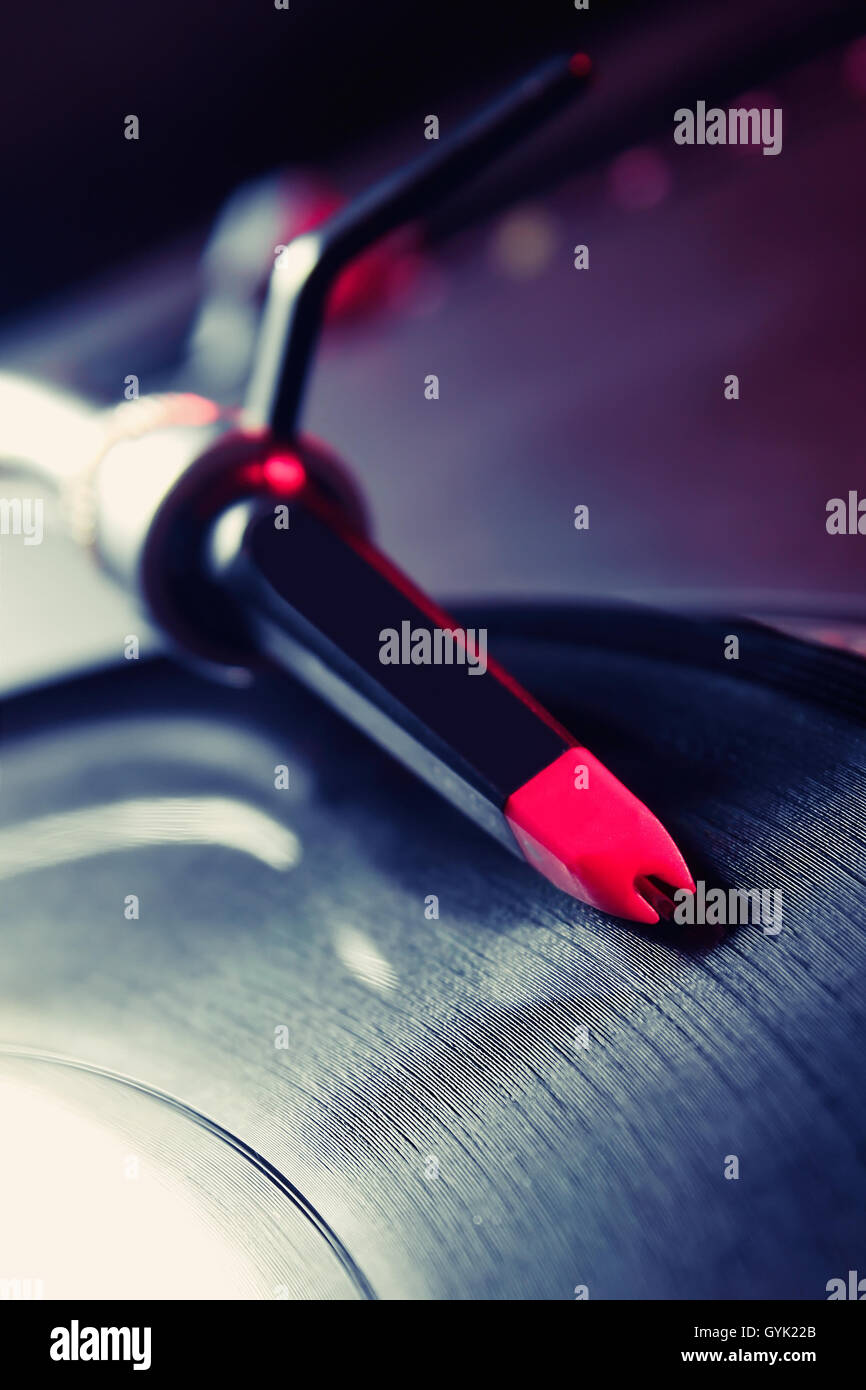 Turntable spinning the disc, close up shot of tonearm with needle Stock Photo