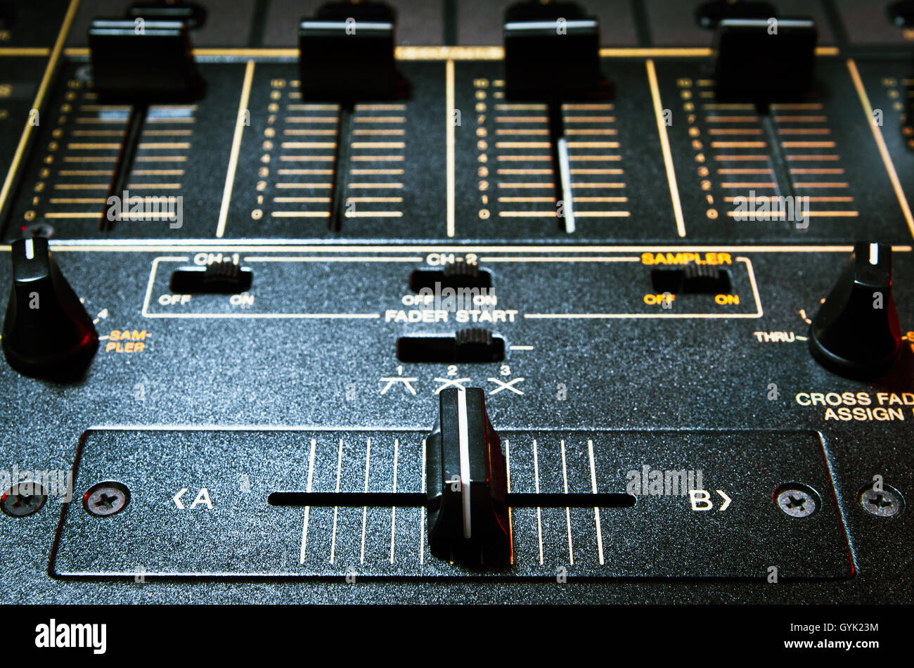 Professional disc jockey audio mixer panel in close up.Focus on crossfader knob.Sound level regulator for mixing music tracks on party in night club Stock Photo