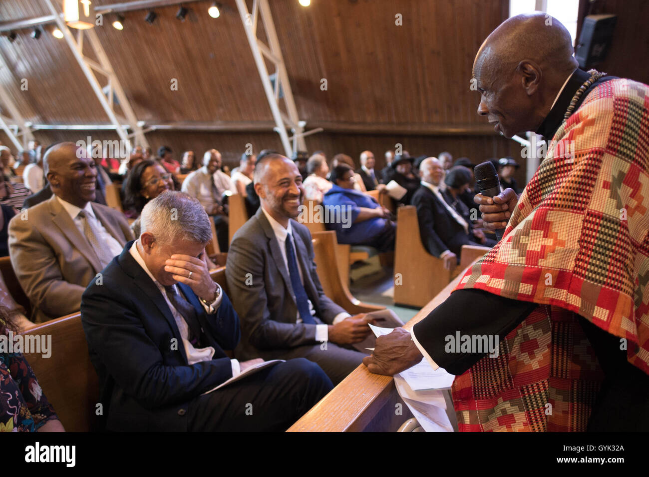 Mayor of London Sadiq Khan (left) laughs as he is introduced to members of the congregation at the St Albans Congregational Church in Queens, New York City (NYC) during a three day visit to the US capital as part of his visit to North America. Stock Photo