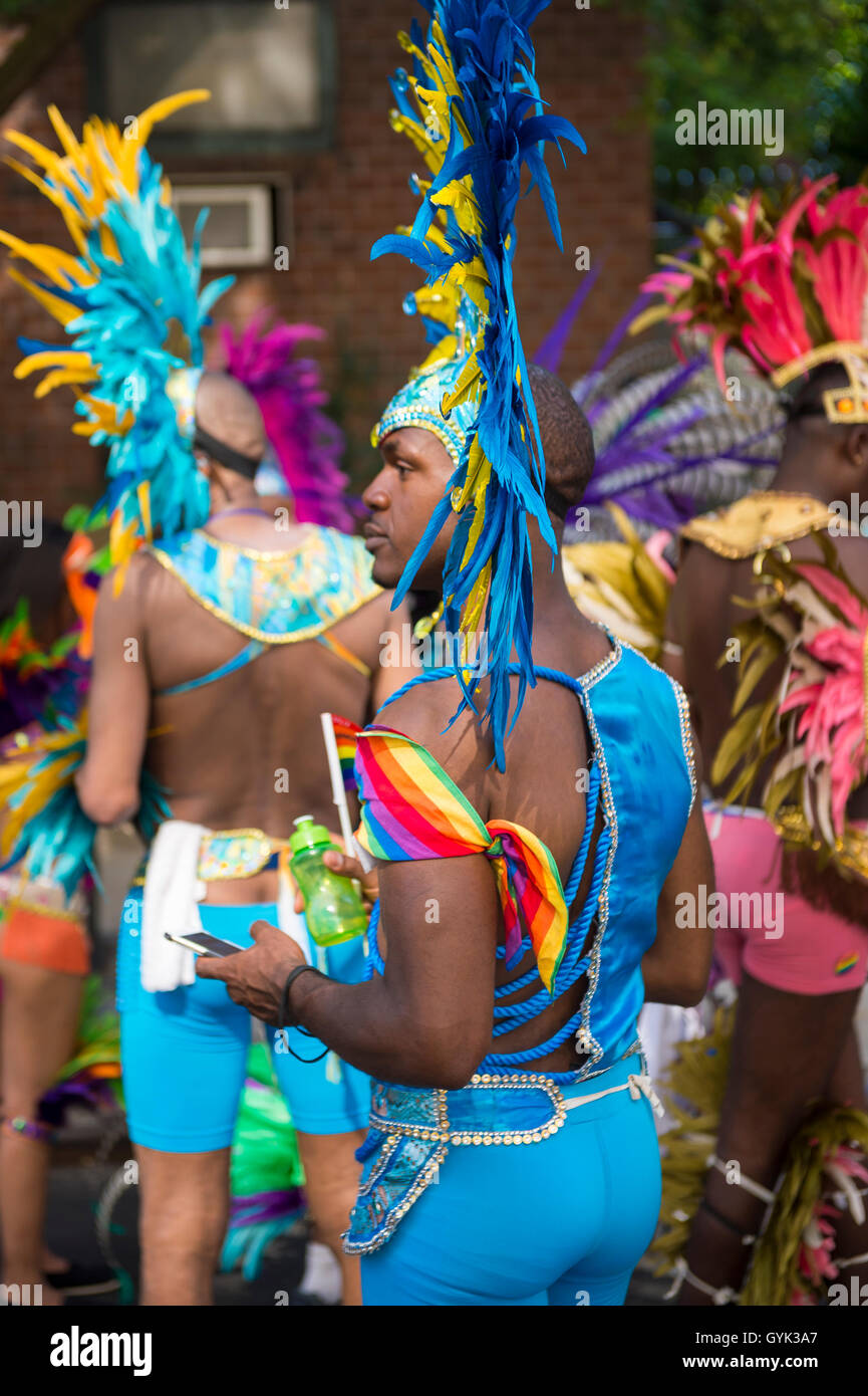 NEW YORK CITY - JUNE 21, 2016: Dancers in flamboyant carnival costumes rest at the end of the annual Gay Pride Parade. Stock Photo