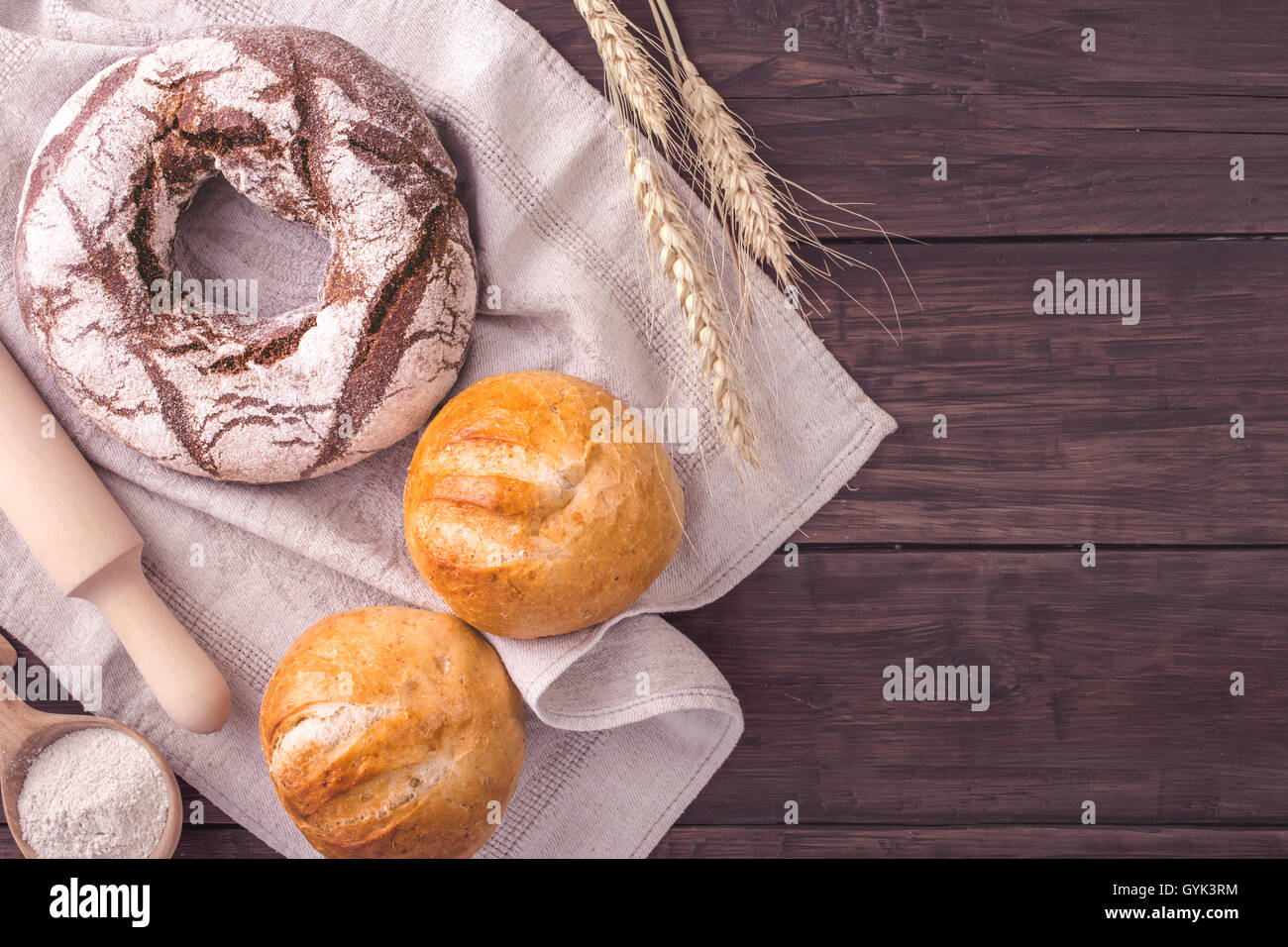 Rye bread and buns on table rustic style Stock Photo